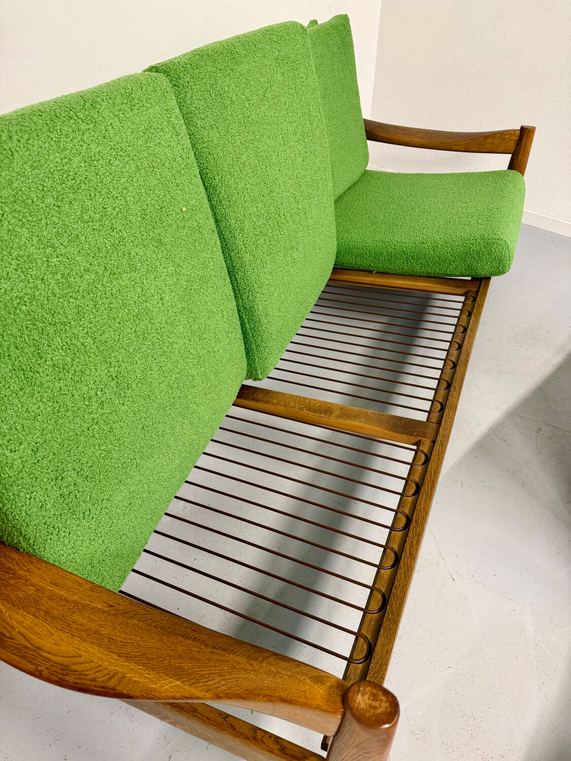 Living room sofa and Scandinavian design armchairs from the 1960s in green boucle.
