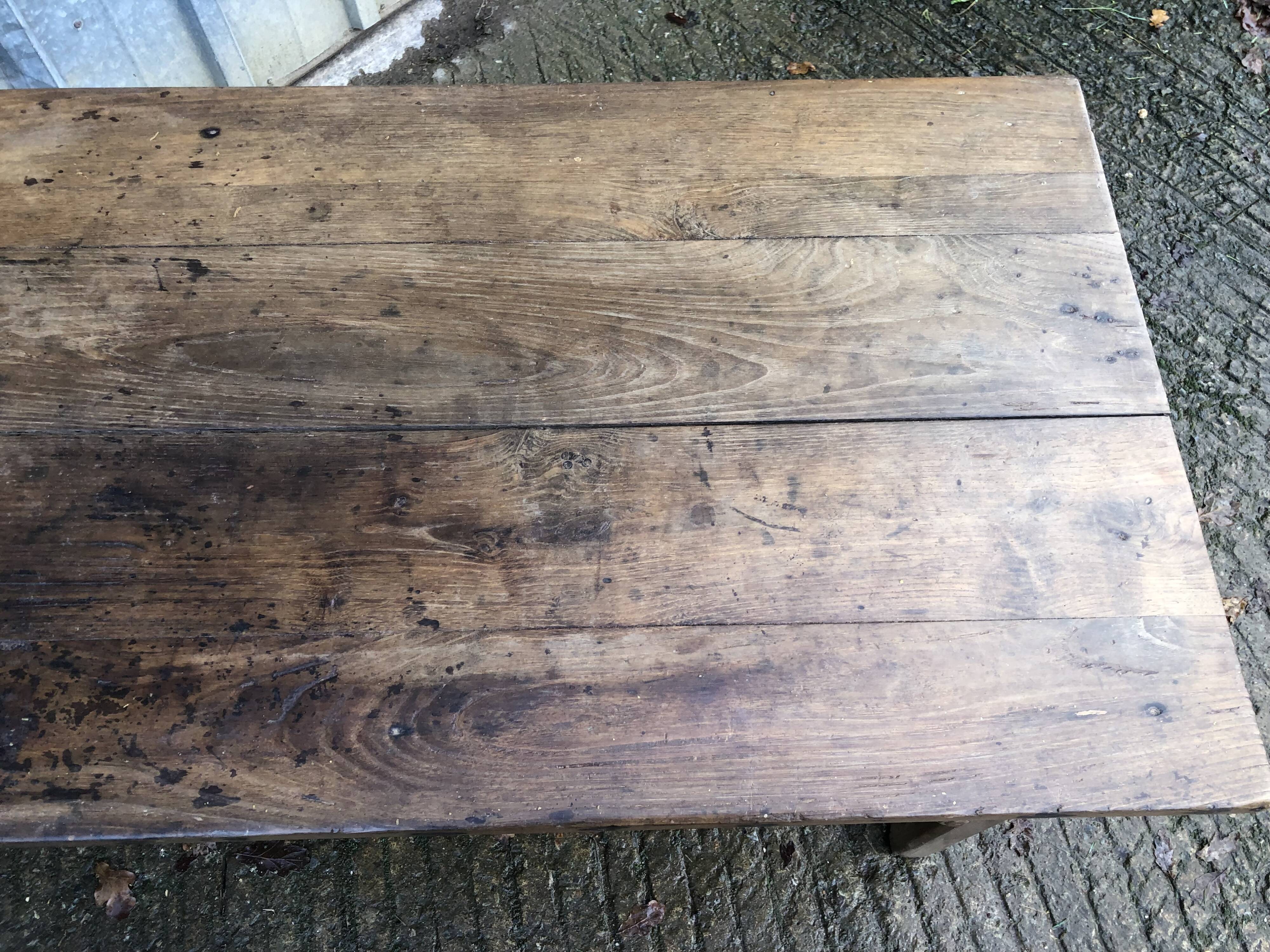 Old chestnut table with 3 front drawers and a cat bar.
