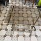 Vintage style side table with magazine holder, gold metal and glass top.