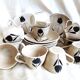 Vintage 23-piece Niderviller coffee set with hand-painted black tulip decor.