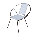 Old relax armchair in black metal and white plastic cannage
