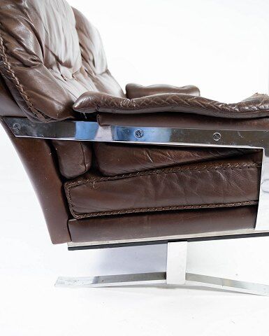 Two seater sofa upholstered with patinated brown leather and frame in metal, designed by Arne Norell