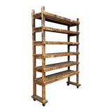 Old wooden workshop shelf with cast iron wheels.