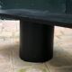 Rectangular coffee table in stained black wood with ball and cylindrical legs.