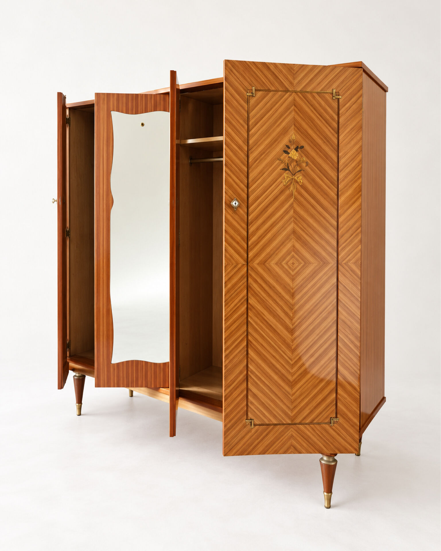 Vintage 1970s wardrobe with floral marquetry, mirrors, and gold details.