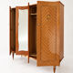 Vintage 1970s wardrobe with floral marquetry, mirrors, and gold details.