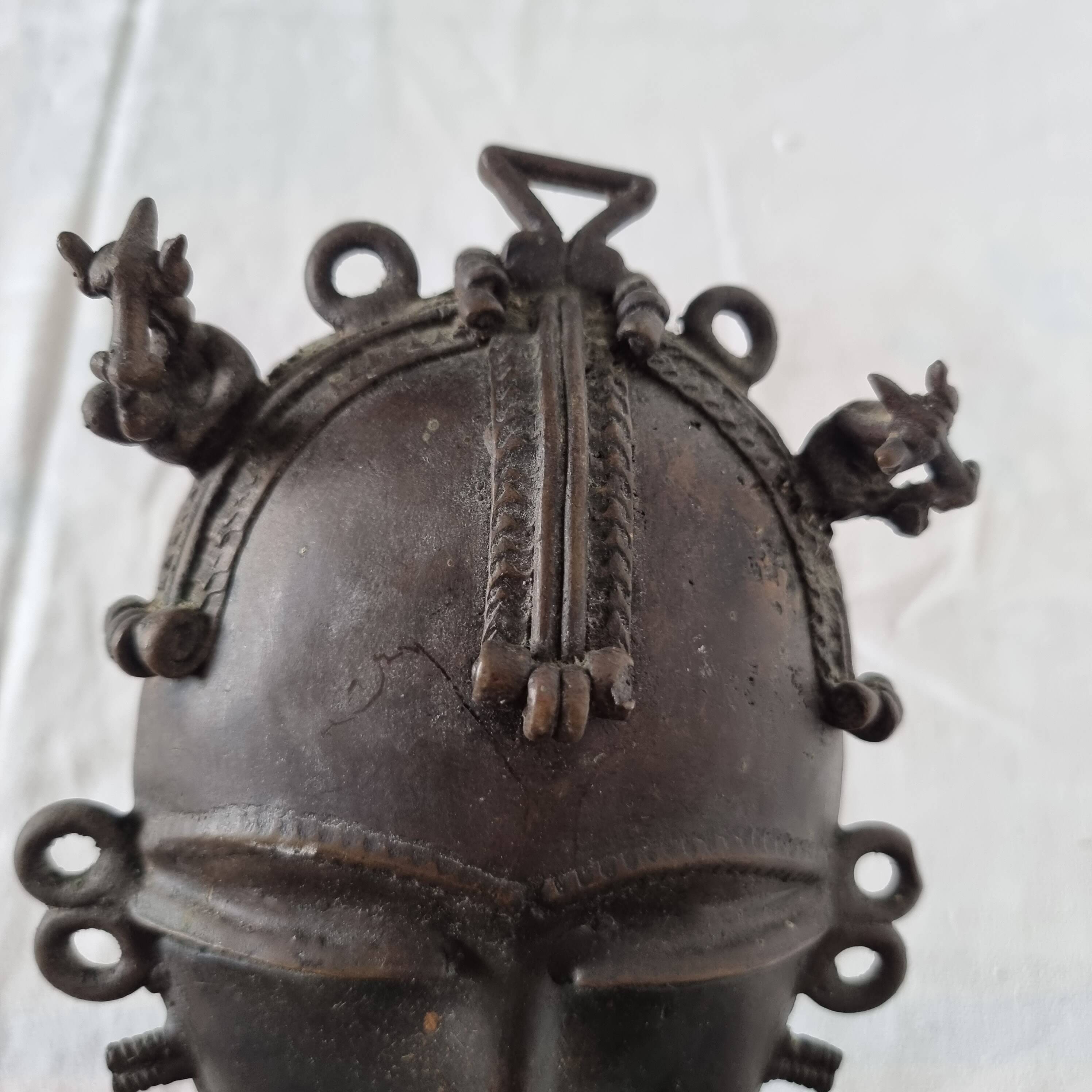 African bronze mask on pedestal, from Ivory Coast, dating