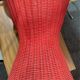 Vintage hourglass stool in red wicker or woven rattan.