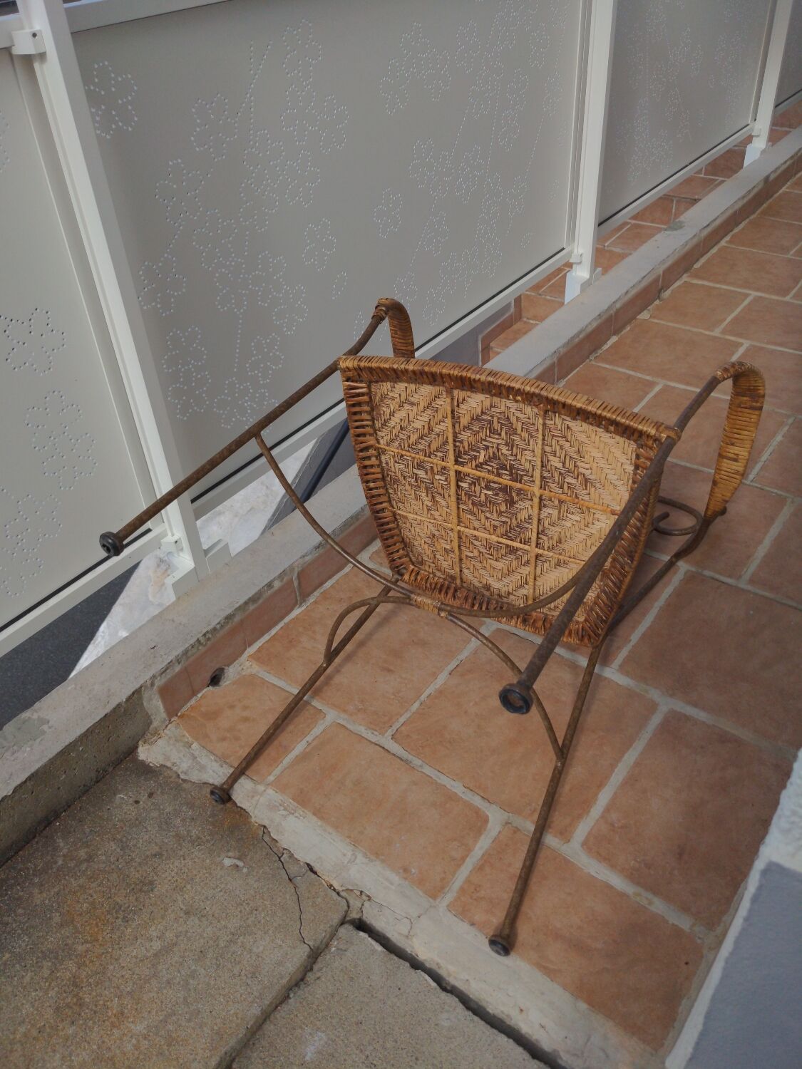 Wicker armchair and wrought iron
