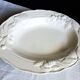 Oval white vegetable dish, an antique tableware piece in barbotine earthenware.