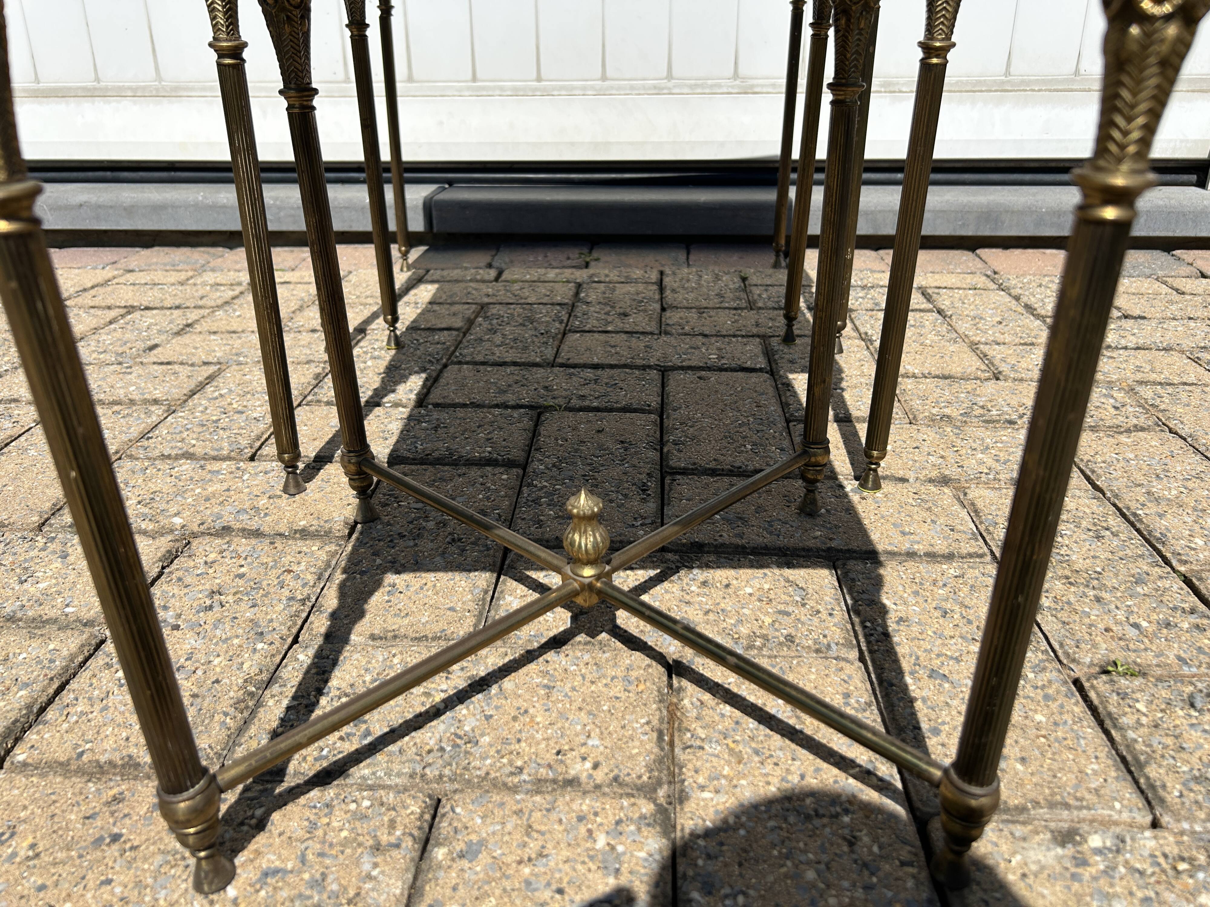 Nested tables in gilded brass in the style of Maison Charles.
