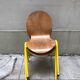 Chaises en bois et structure jaune