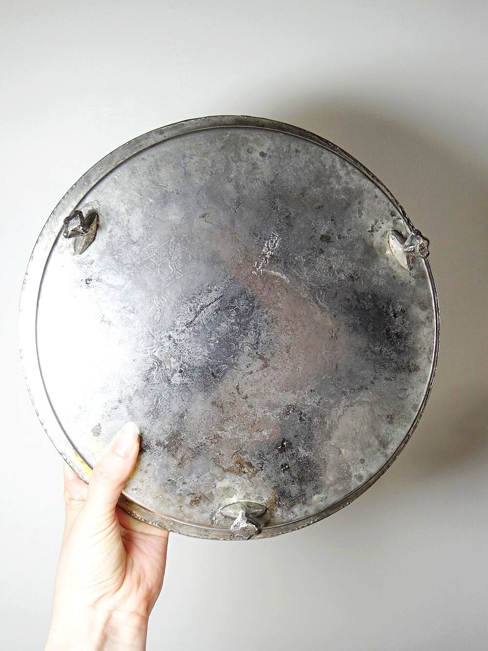 Small Moroccan tripod tea tray in silver-plated metal, vintage chiseled decoration.