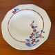 Saint Amand hollow plates decorated with red and blue flowers