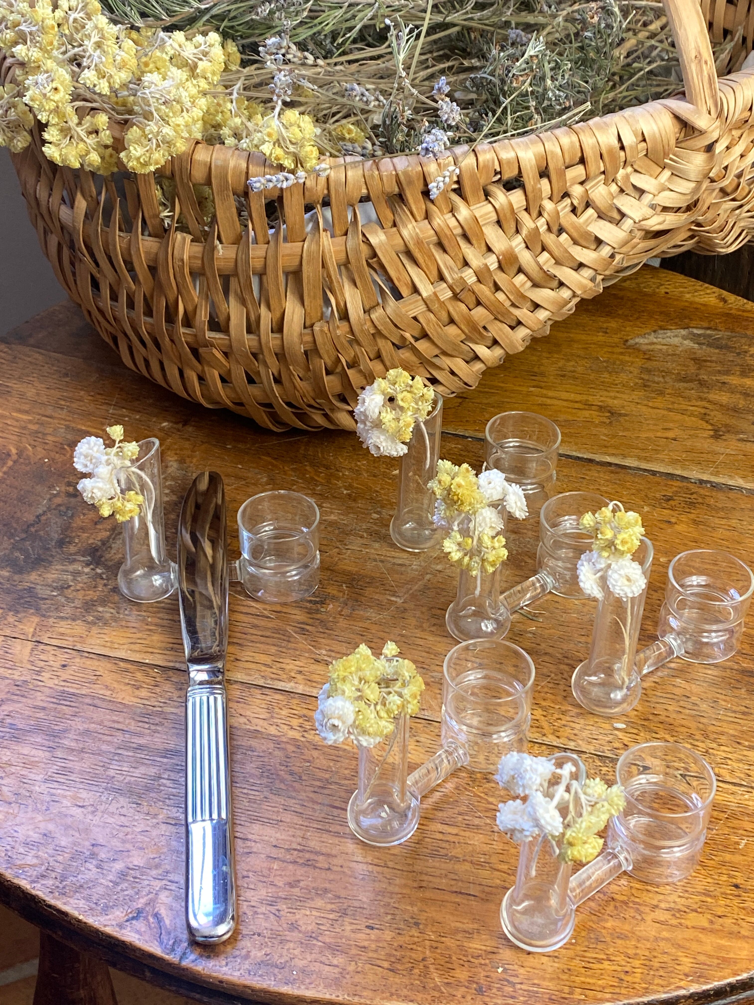 Knife rests, flower vases and candle holders in blown glass.