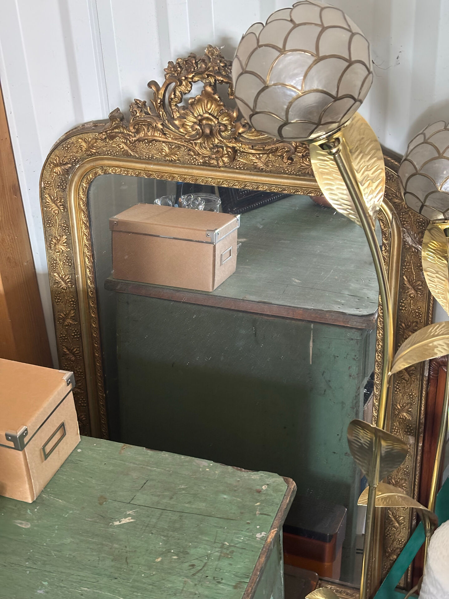 Golden mirror with a pediment from the early 20th century.
