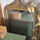 Golden mirror with a pediment from the early 20th century.