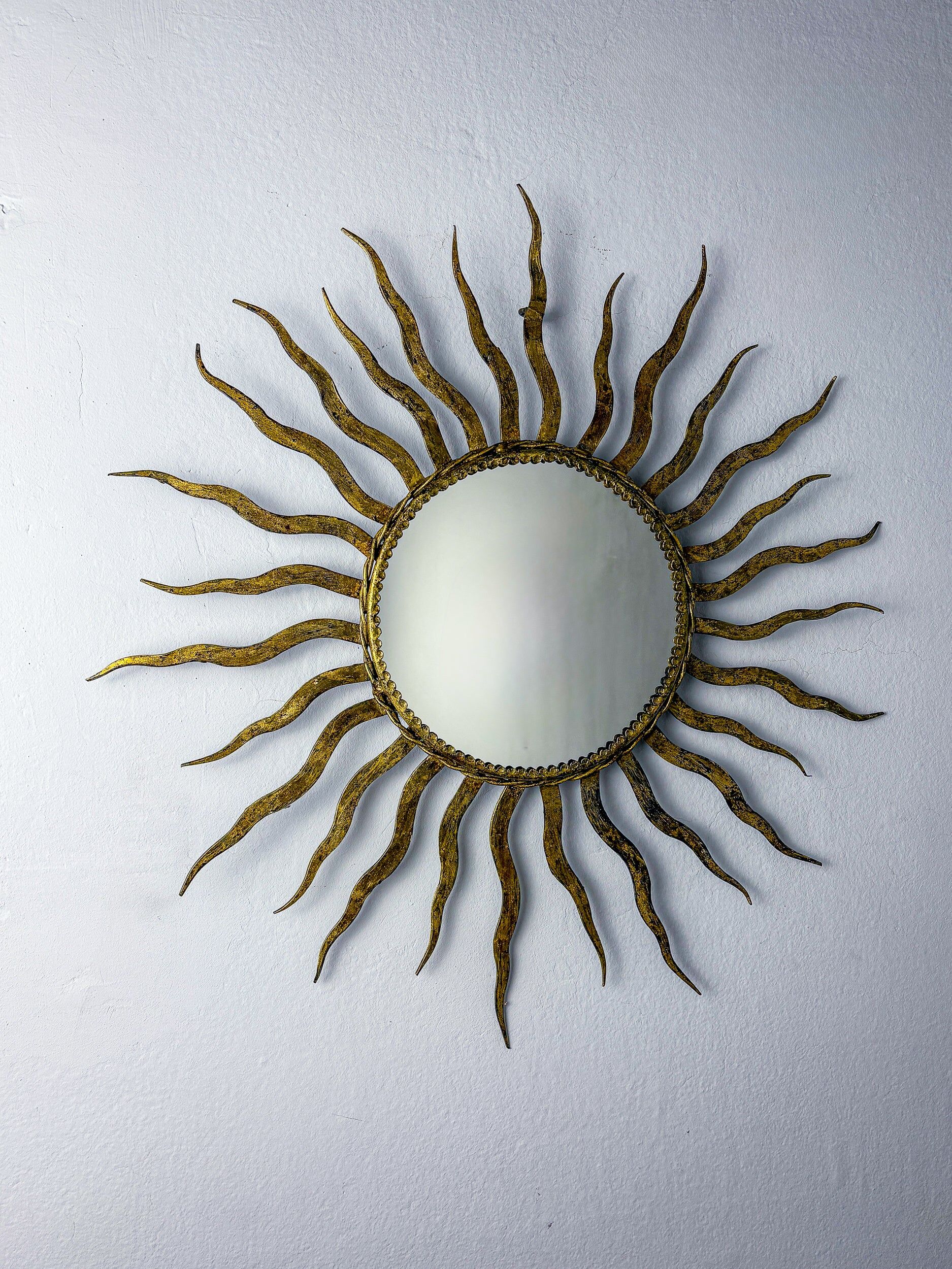 French sunburst starburst mirror in gilt iron, 1950s