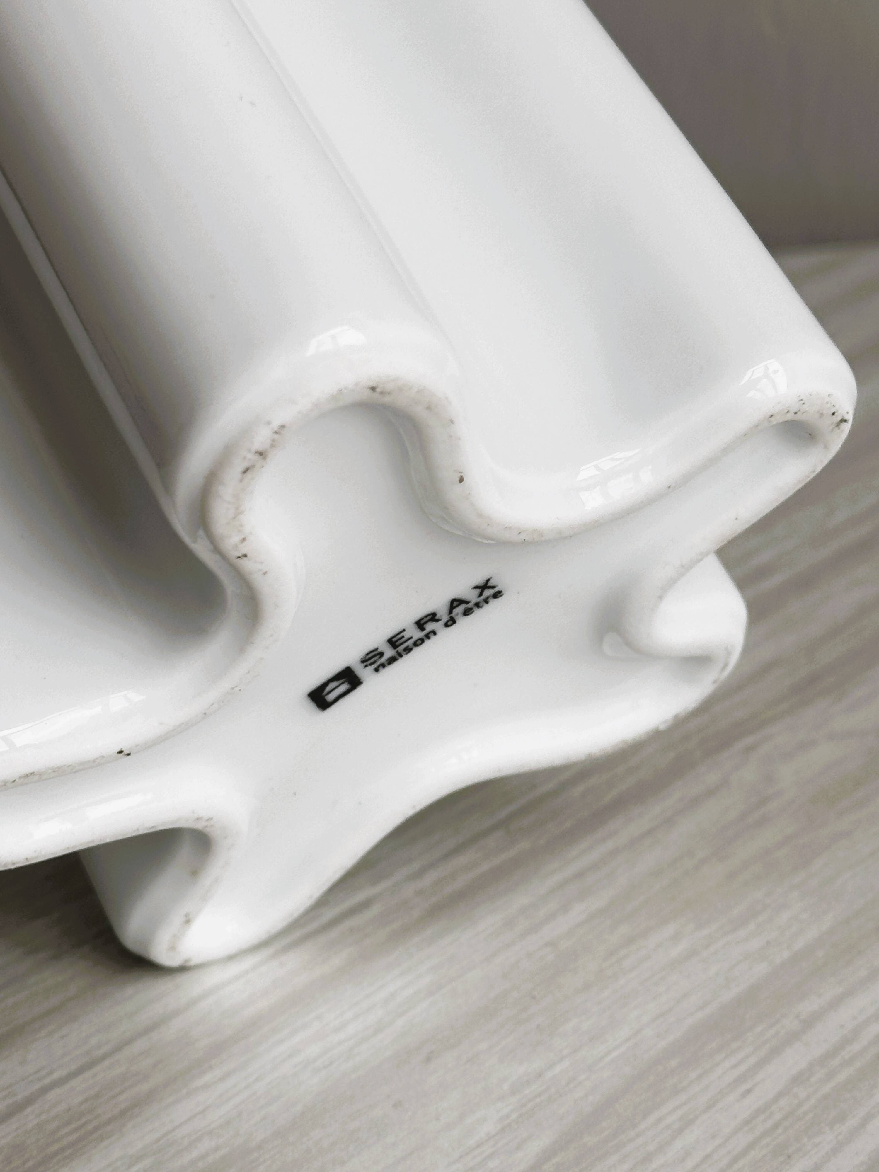 Modern white ceramic vase with wavy curves