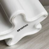 Modern white ceramic vase with wavy curves