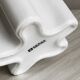 Modern white ceramic vase with wavy curves