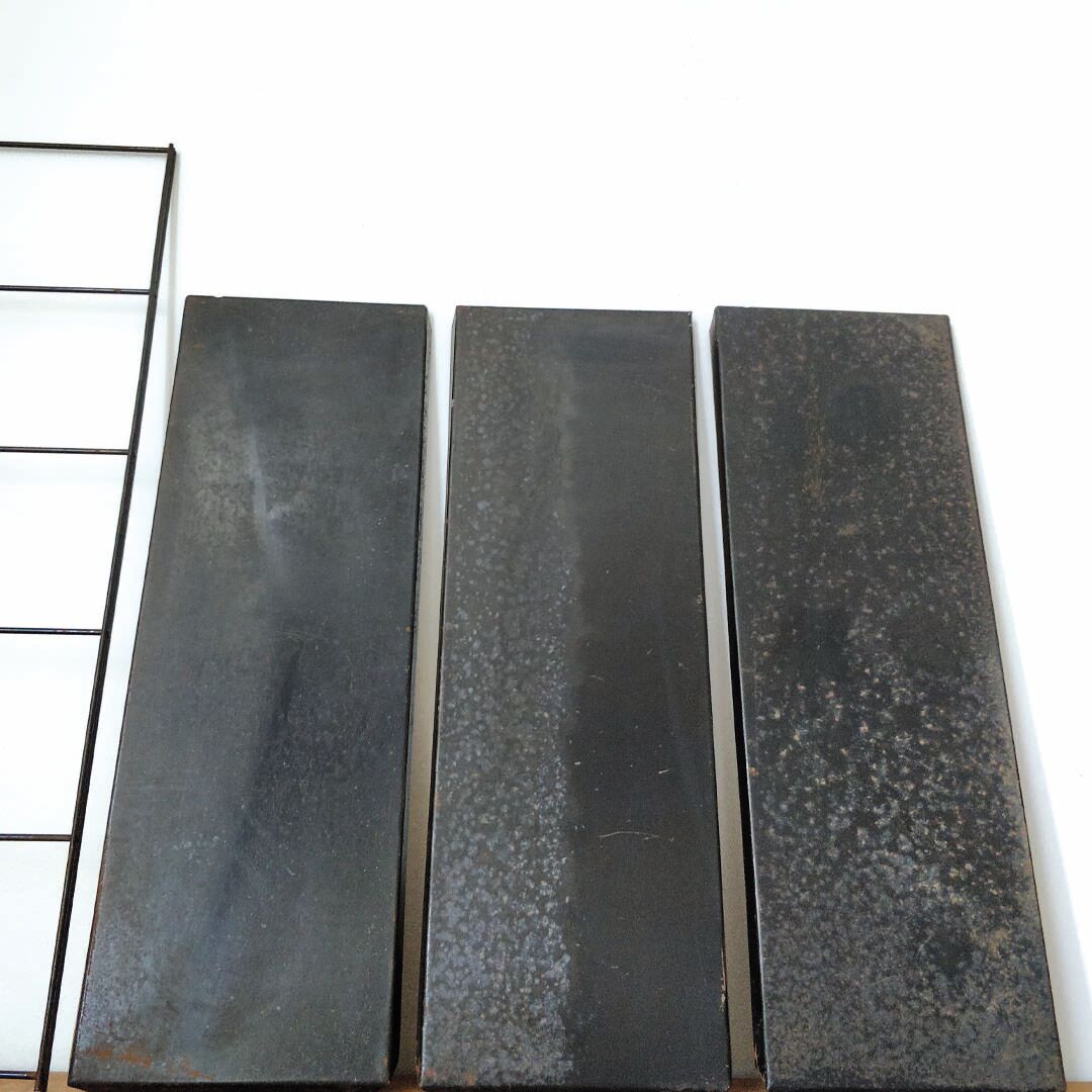 Patinated metal wall shelf