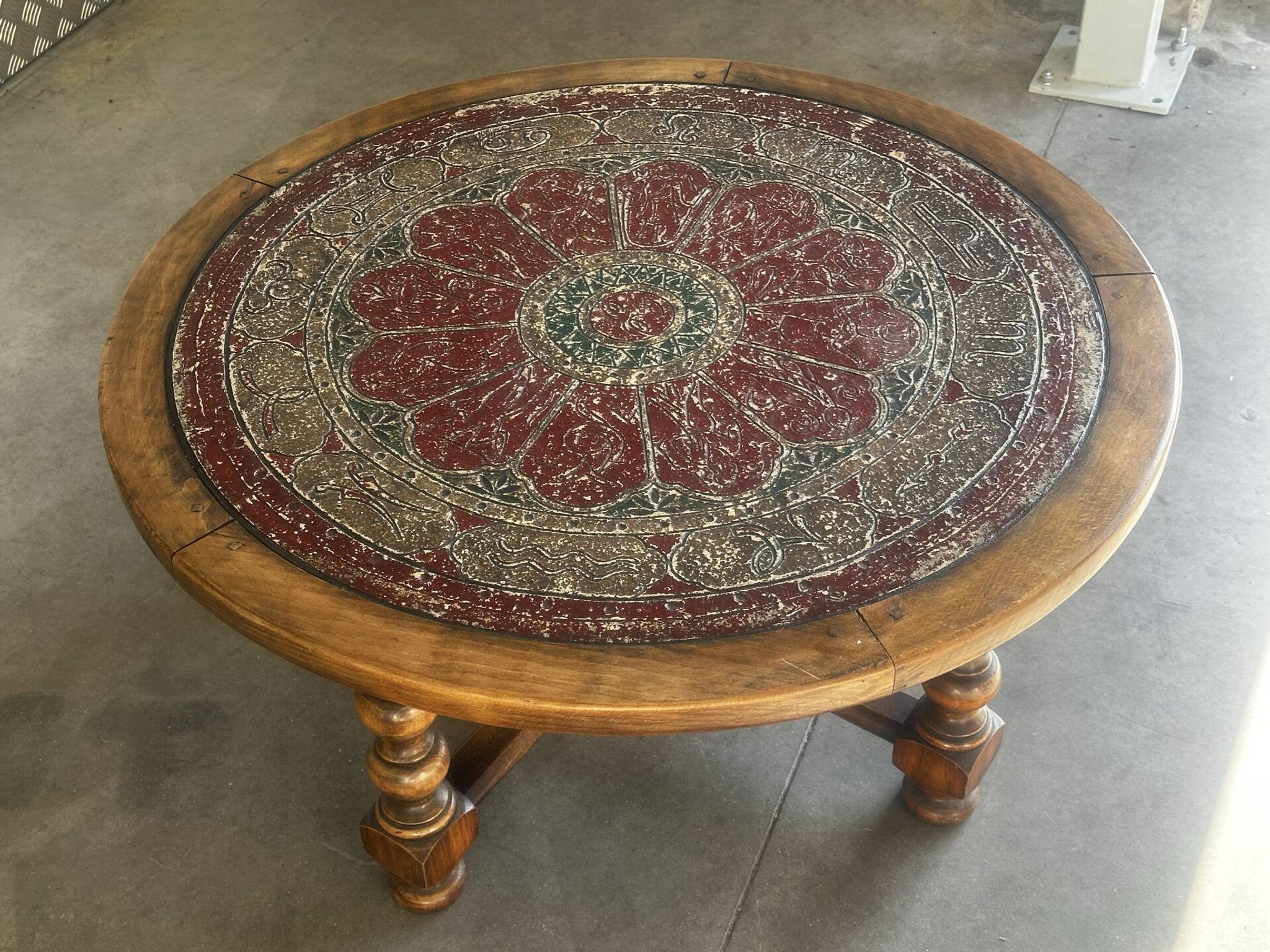 Vintage wooden turned coffee table with leather and astrological decoration.