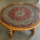 Vintage coffee table in turned wood and leather with astrological decoration.