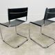 Paire de chaises cantilever simili cuir noir et chrome