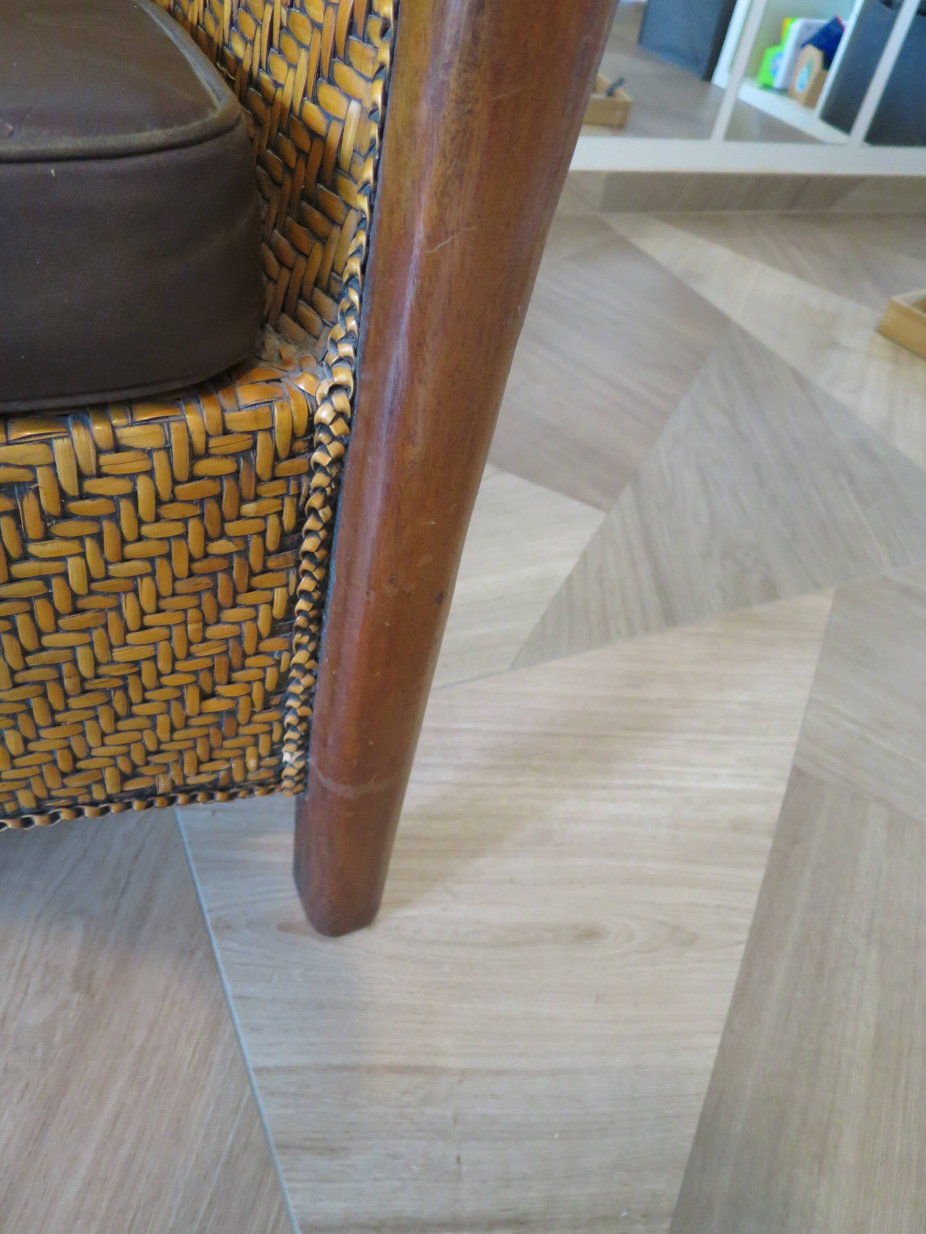Colonial style armchair in woven rattan and exotic wood
