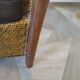 Colonial style armchair in woven rattan and exotic wood