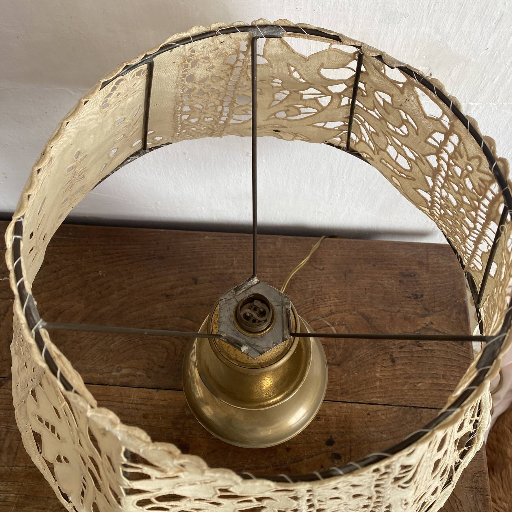 Antique brass lamp with embroidered openwork shade.