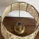Antique brass lamp with embroidered openwork shade.