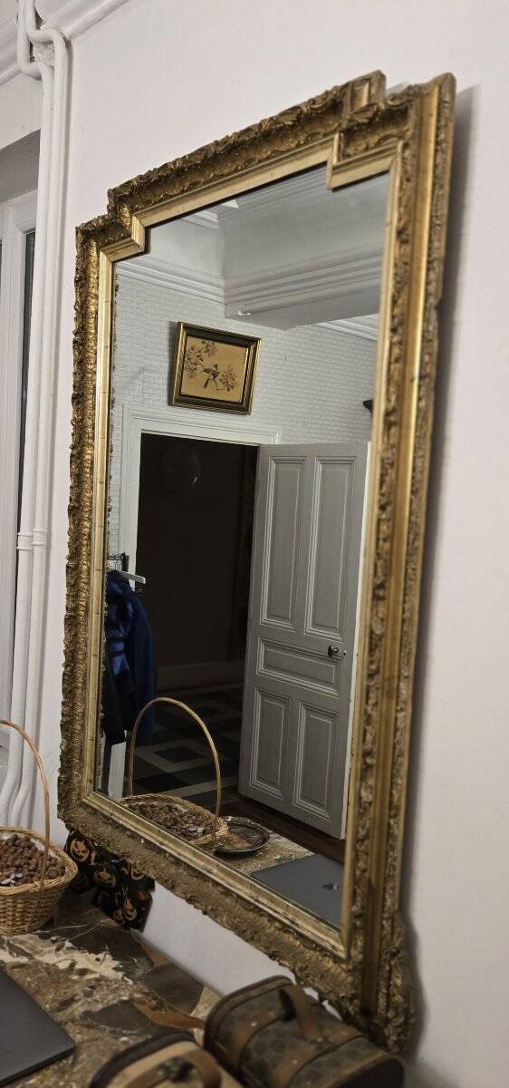 Large antique mirror from the Napoléon III era, finely carved and gilded with gold leaf.