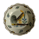 Assiette de Nevers en faïence fin XVIIIe siècle décor de coq sur barrière