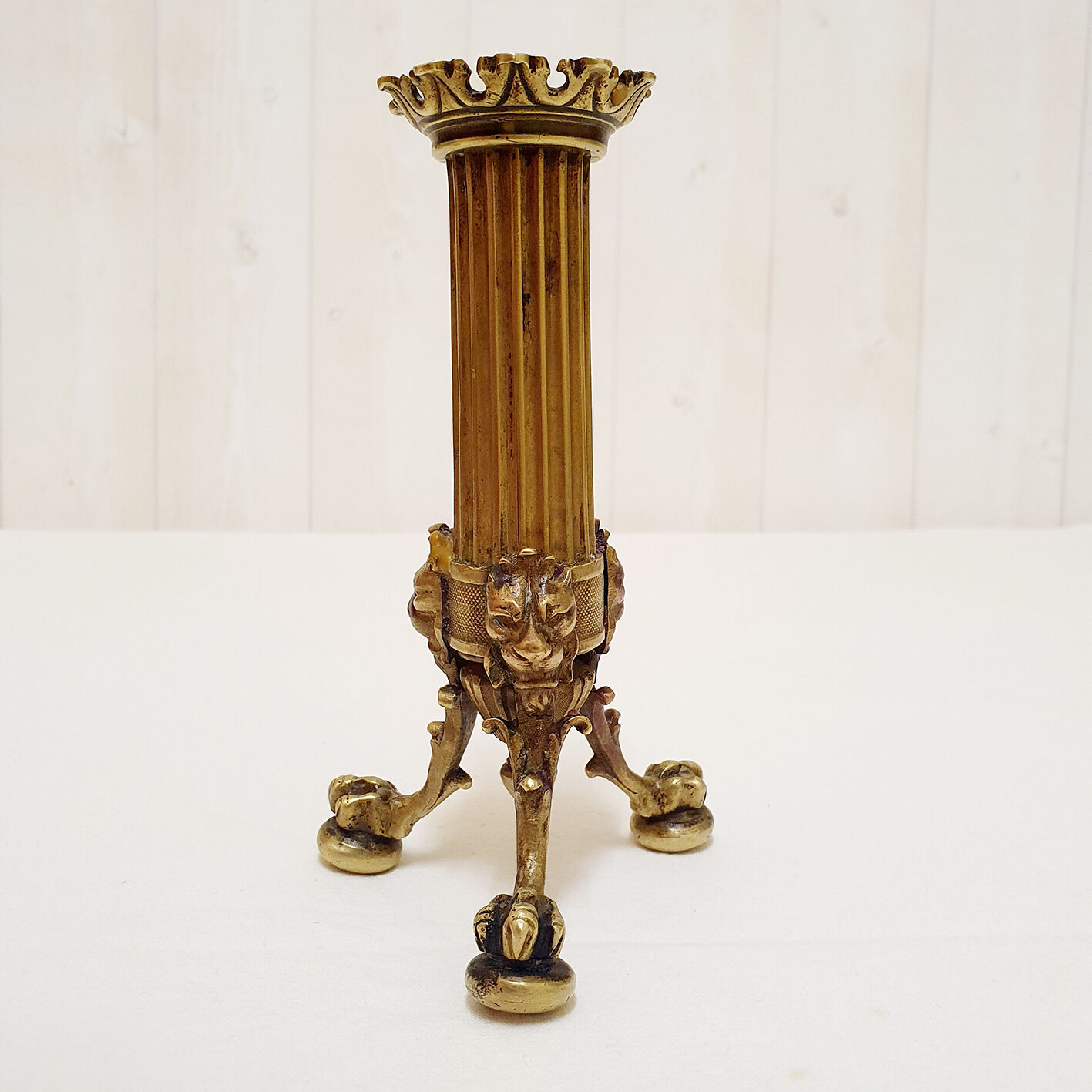 Golden candle holder with lion's head and legs