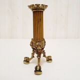 Golden candle holder with lion's head and legs