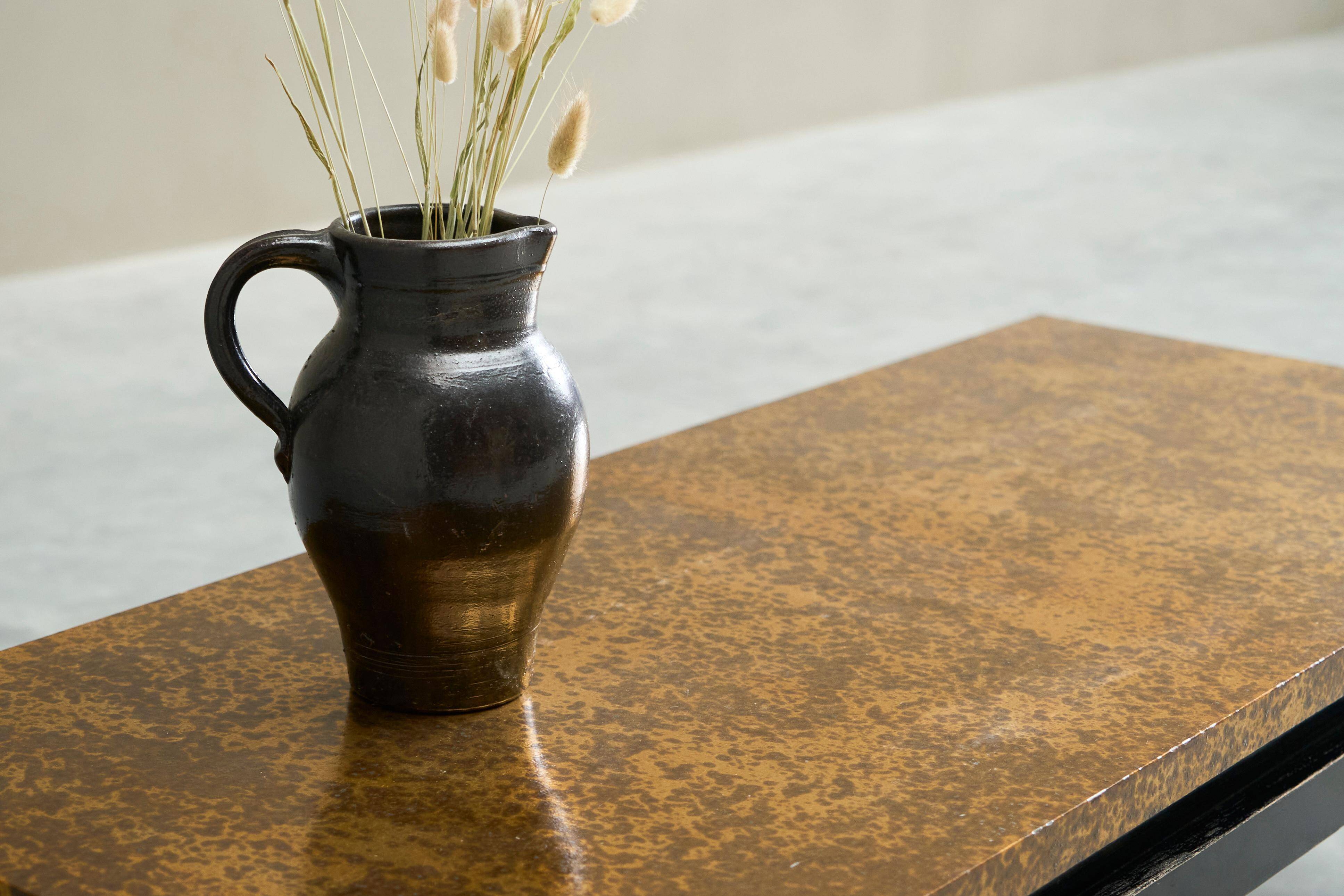 Modernist coffee table with a patinated gold top, 120x52.5x36 cm, mid-20th century.