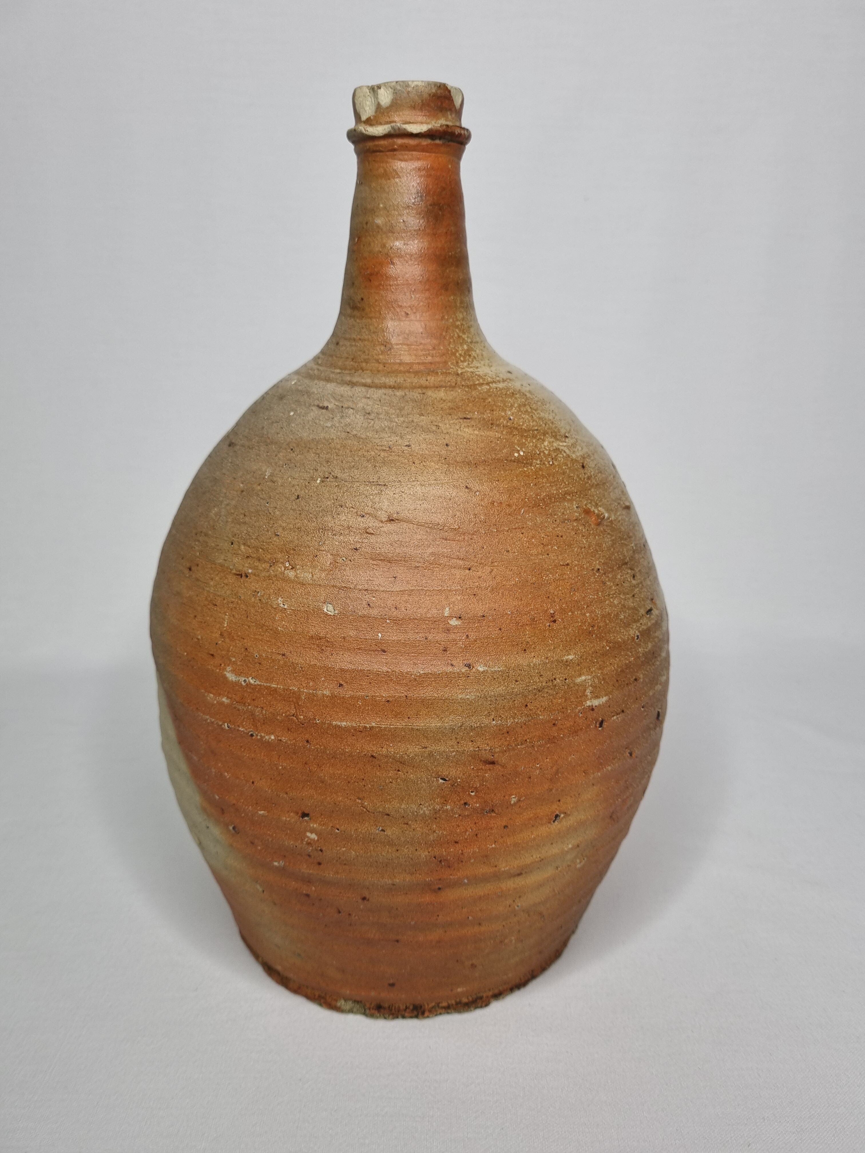Set of three enamelled terracotta bottles