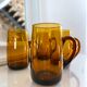 4 mugs/ mugs in vintage blown amber glass