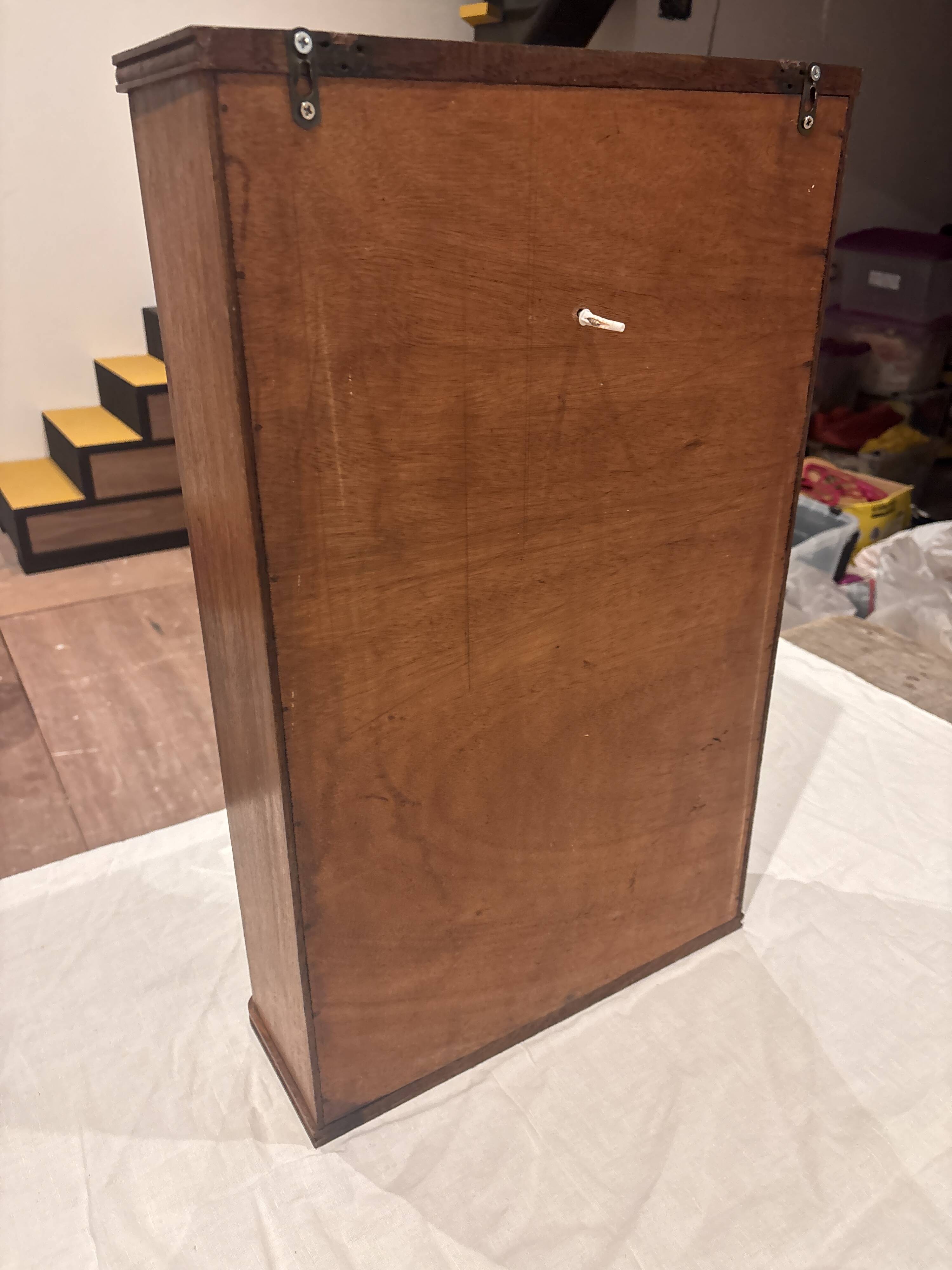 Wall cabinet with oval wall and drawer