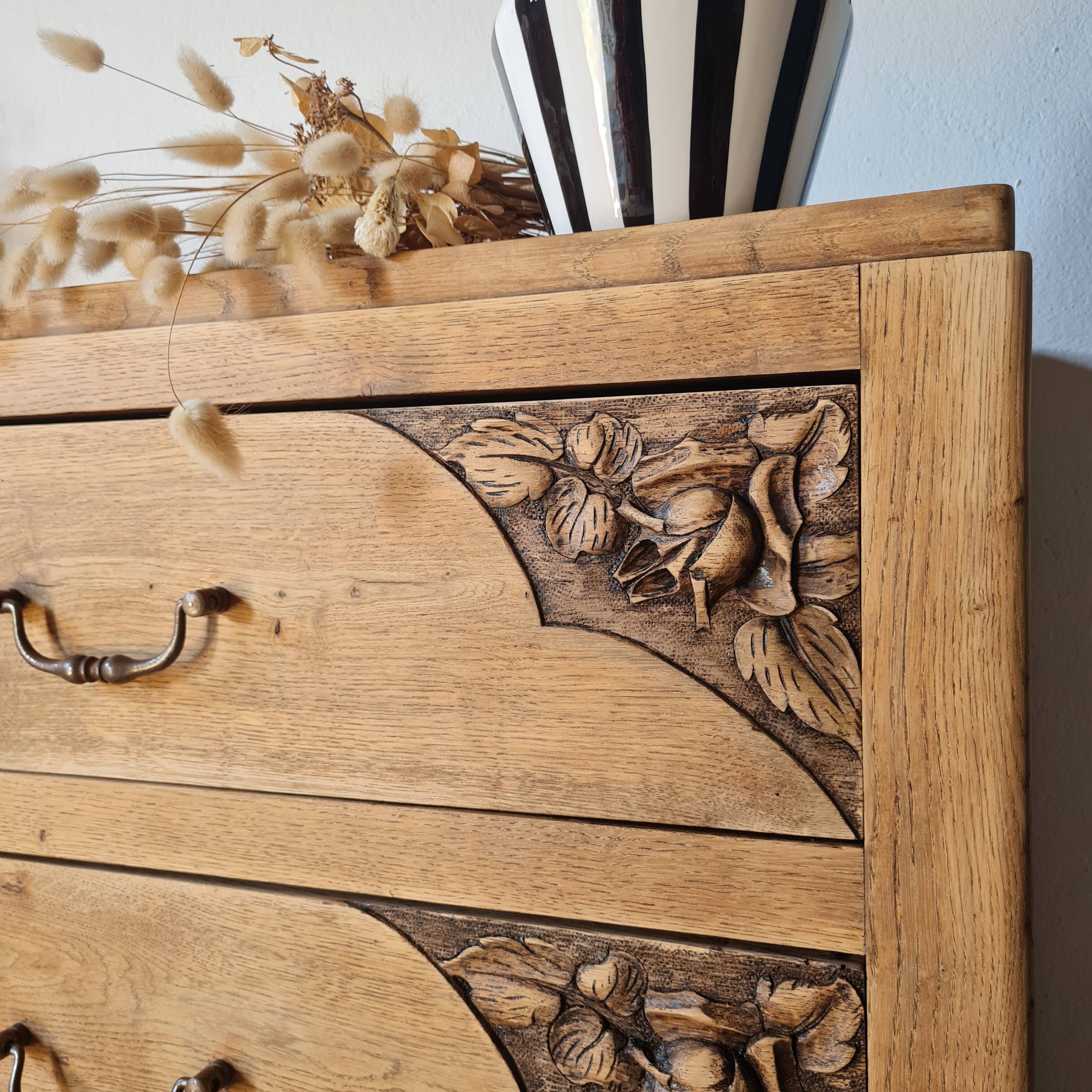 Art Deco chest of drawers in raw oak with carved drawers.