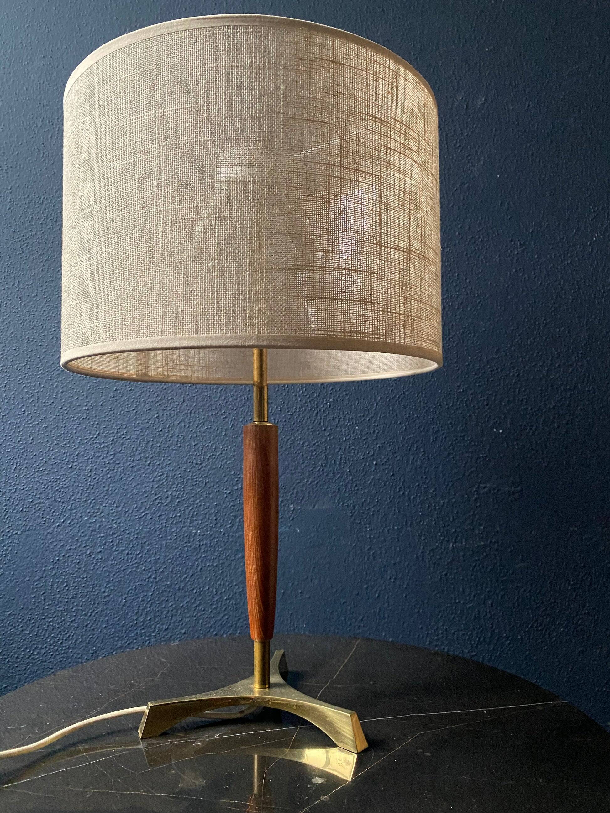 Elegant table lamp with a slender teak body on a tripod brass base, Germany, 1960s.