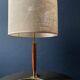 Elegant table lamp with a slender teak body on a tripod brass base, Germany, 1960s.
