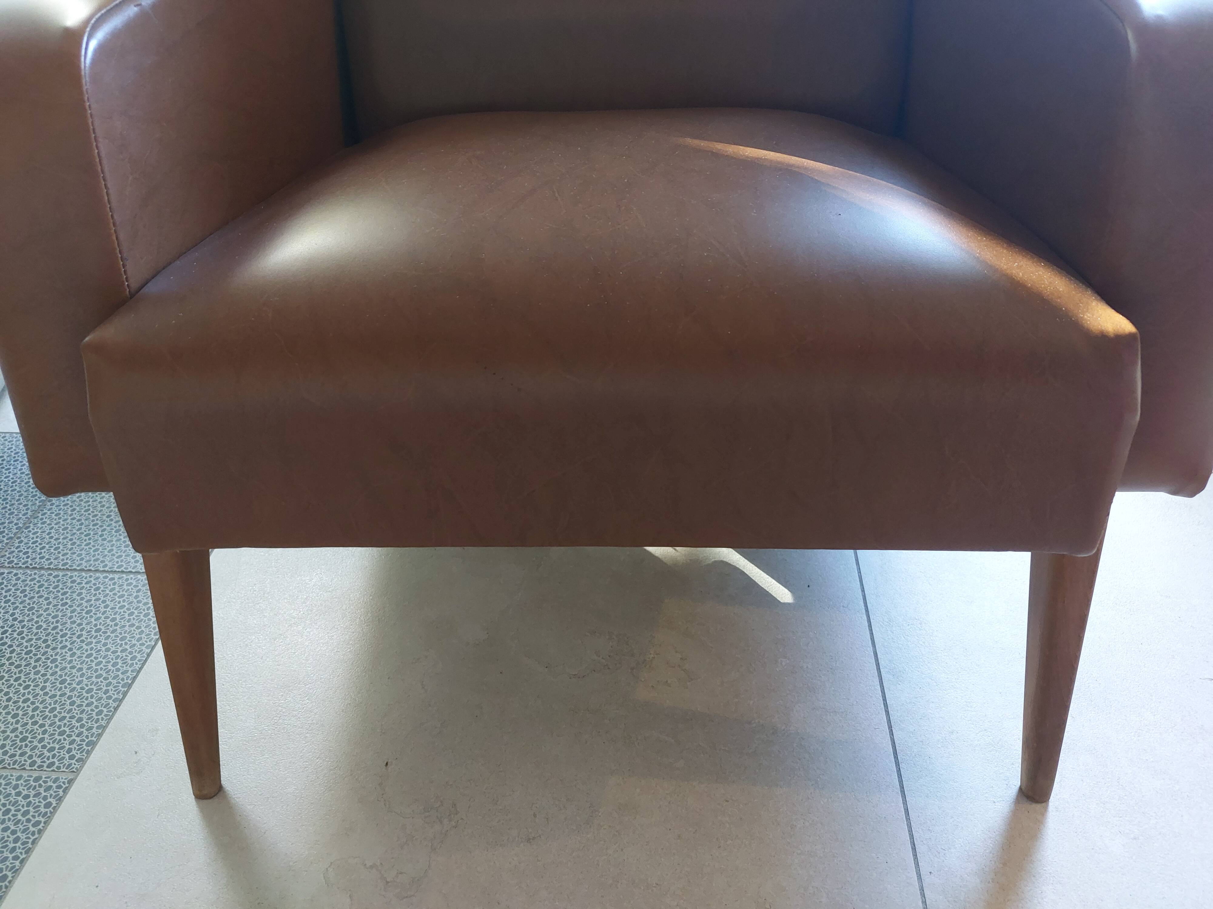 a pair of comfortable vintage armchairs with splayed legs