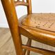 Pair of curved wood bistro chairs and studded and perforated seat
