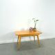 Vintage veneer table with pretty angular legs and brass at the base of the legs.