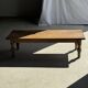 Brown Indonesian teak coffee table, with a border and cylindrical legs H40 L103.