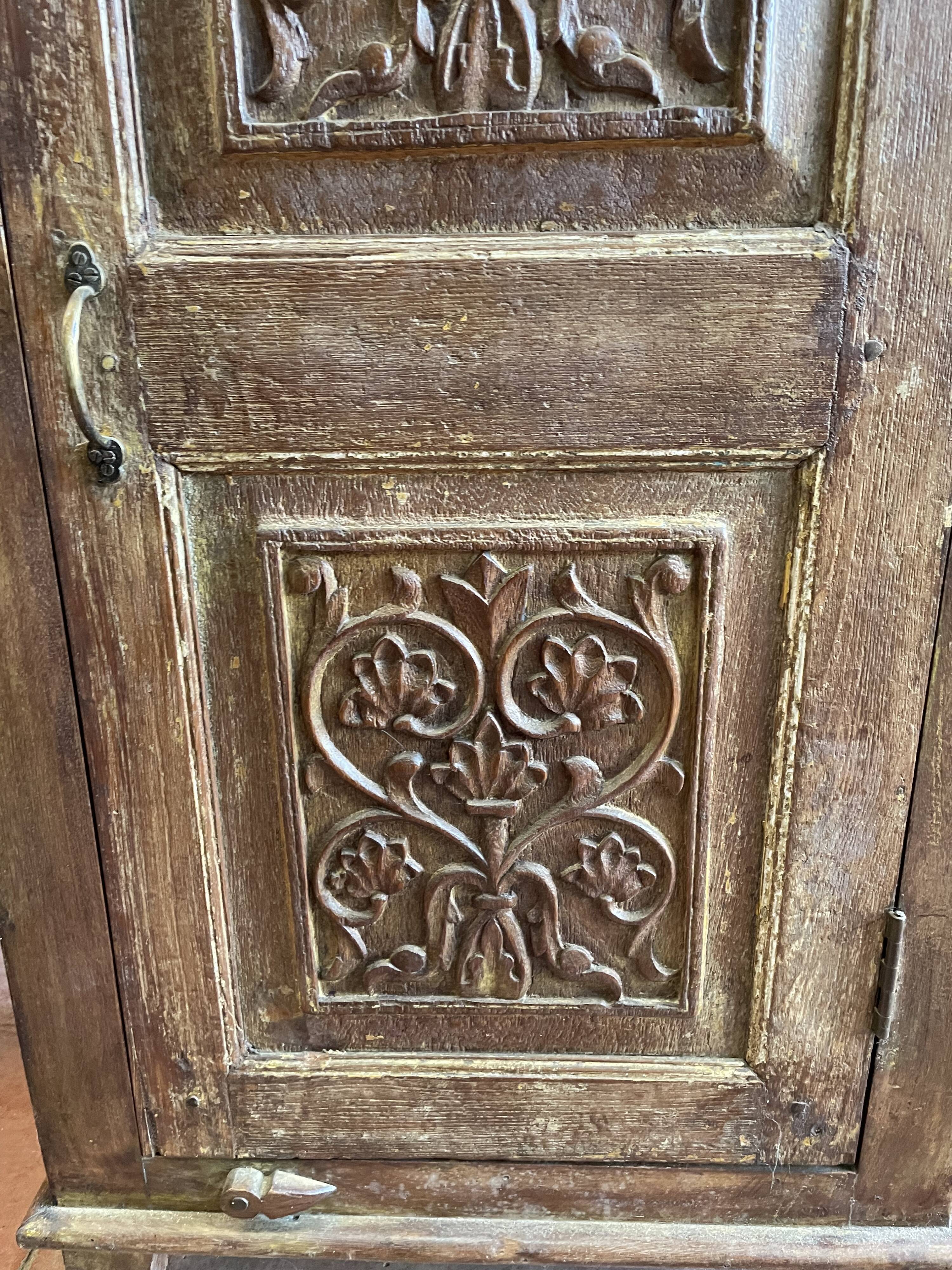 India. Bonnetière with a teak door finely carved by hand.