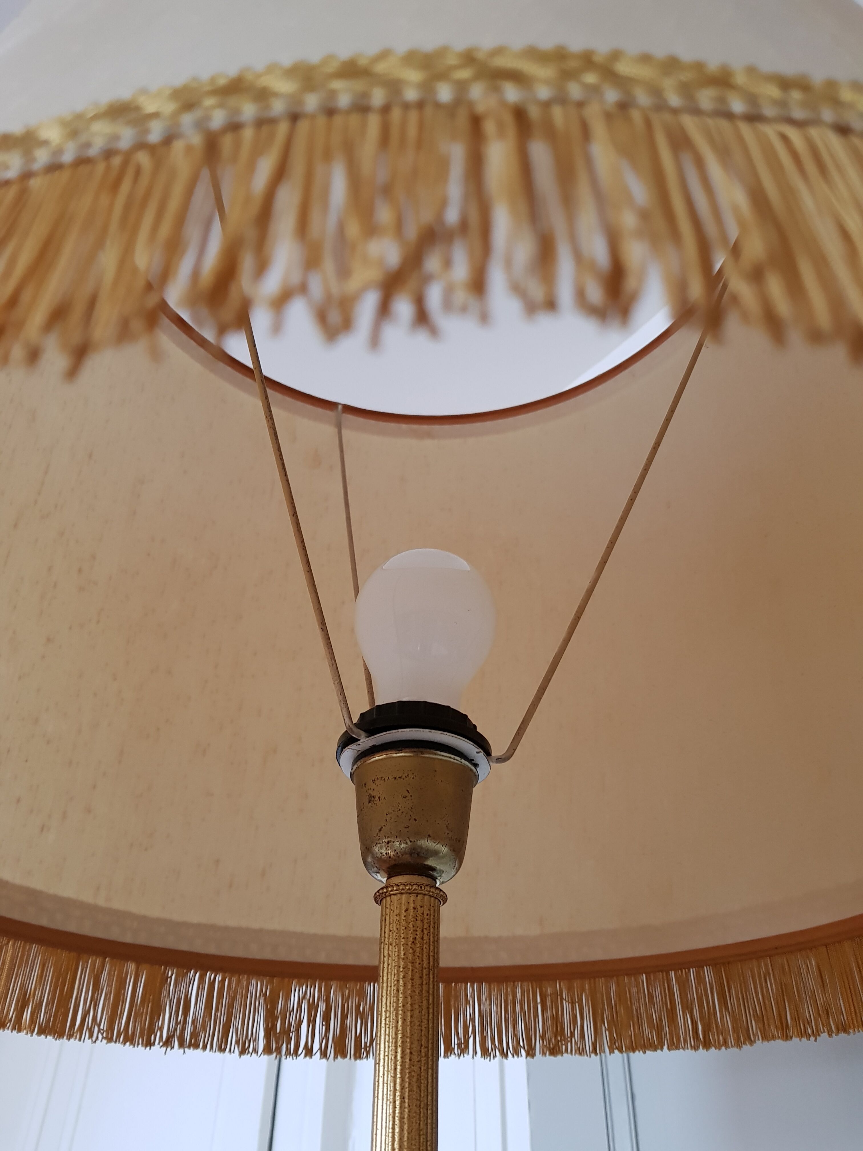Authentic antique lamppost in gilded brass lampshade in fringed cream fabric